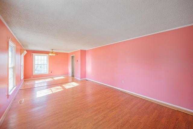 unfurnished room with crown molding, wood-type flooring, and ceiling fan