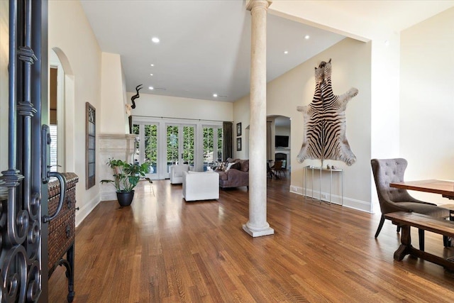 living room with hardwood / wood-style floors and ornate columns