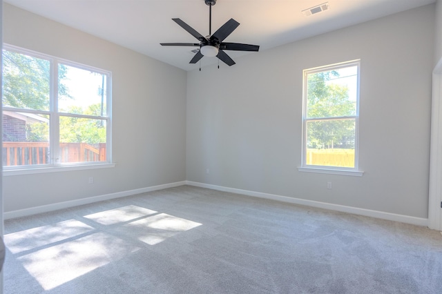 unfurnished room with ceiling fan and light carpet