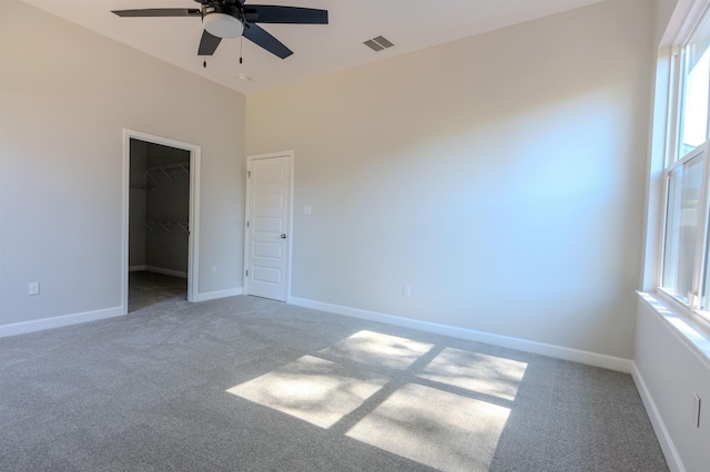 carpeted spare room with ceiling fan