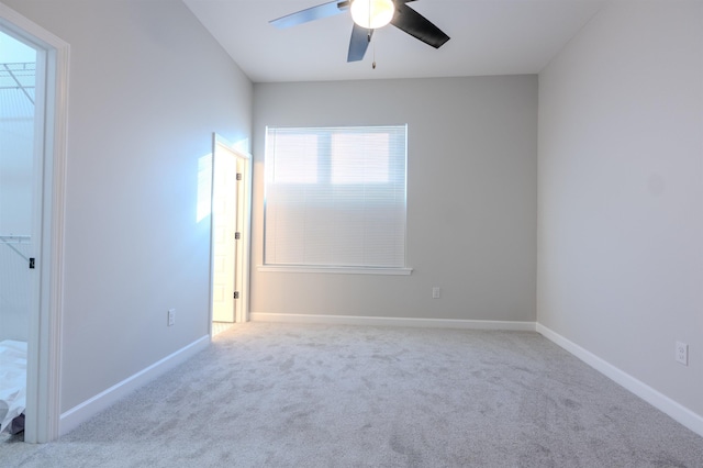 spare room featuring ceiling fan and light colored carpet