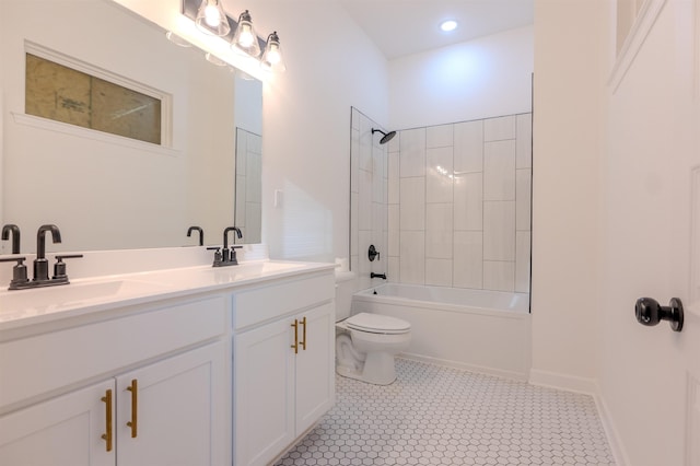 full bathroom with tile patterned flooring, vanity, tiled shower / bath, and toilet