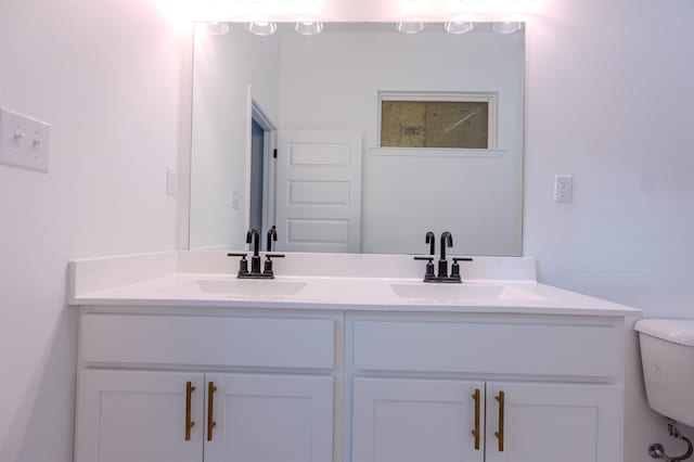 bathroom with toilet and vanity