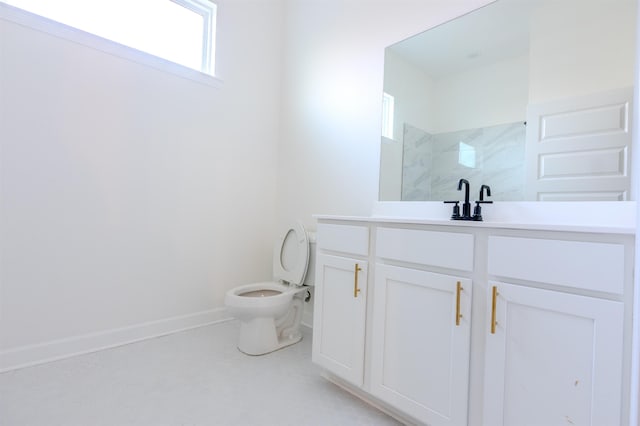 bathroom featuring vanity, toilet, and walk in shower