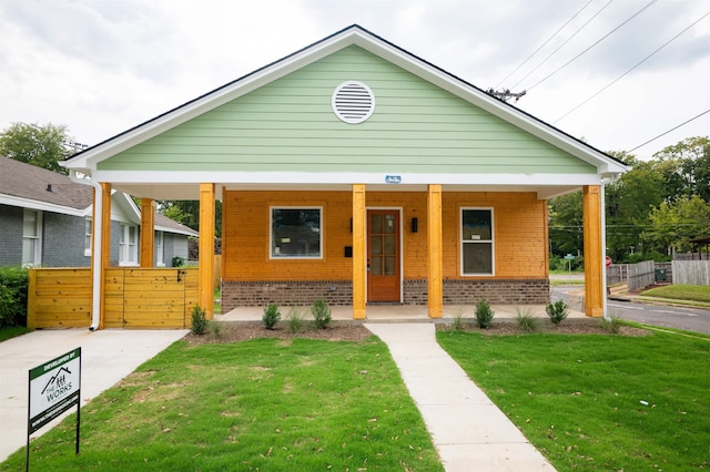 bungalow-style house with a front yard and a porch