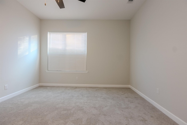 unfurnished room with ceiling fan and light colored carpet