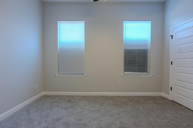 unfurnished room with ceiling fan, light carpet, and a healthy amount of sunlight