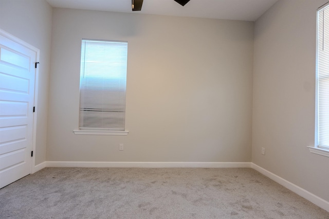 carpeted empty room featuring ceiling fan