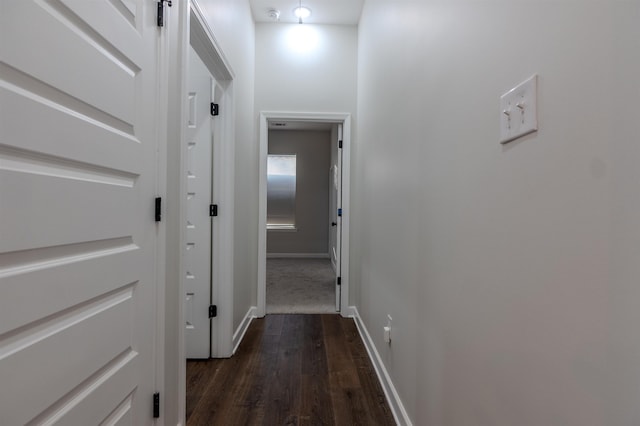 corridor with dark hardwood / wood-style flooring