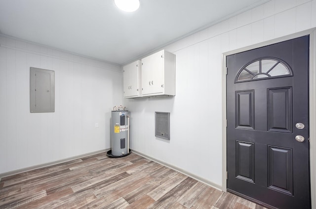 laundry room featuring light hardwood / wood-style floors, ornamental molding, electric panel, and electric water heater