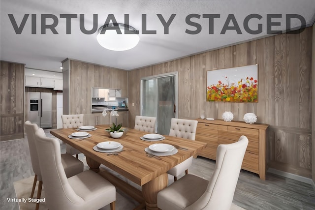 dining space featuring hardwood / wood-style flooring and wood walls