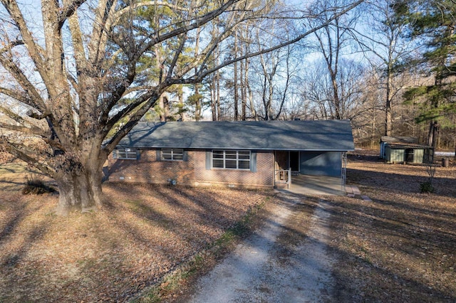 ranch-style home featuring a carport