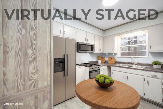kitchen featuring sink, light hardwood / wood-style floors, white cabinets, and appliances with stainless steel finishes