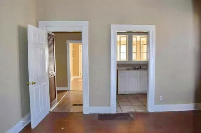 unfurnished bedroom with sink and light tile patterned flooring