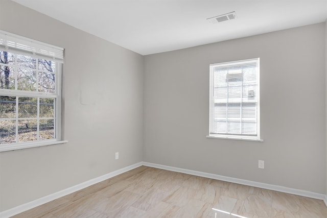 unfurnished room featuring plenty of natural light