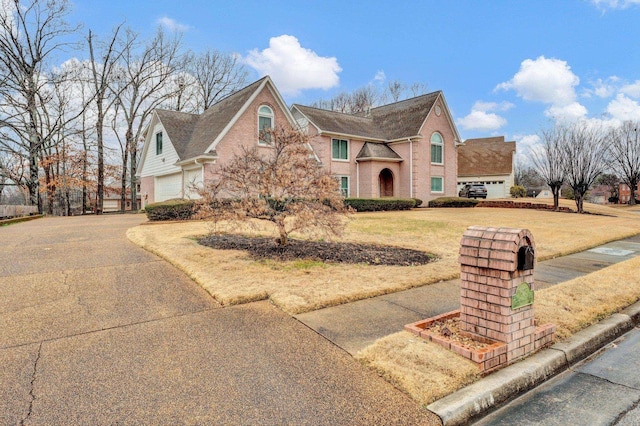 view of front of house with a garage and a front yard