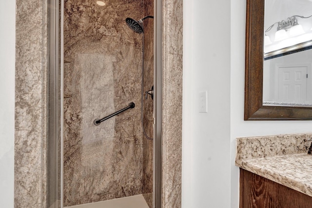 bathroom with vanity and a tile shower