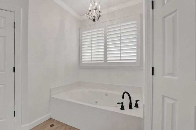 bathroom featuring crown molding, a bathing tub, wood-type flooring, and a chandelier