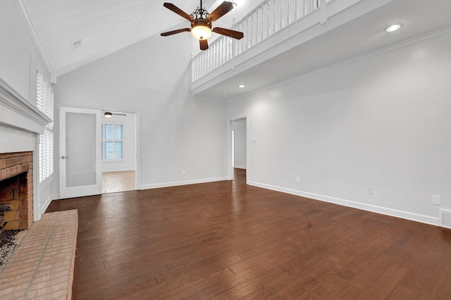 unfurnished living room featuring ornamental molding, a fireplace, and high vaulted ceiling