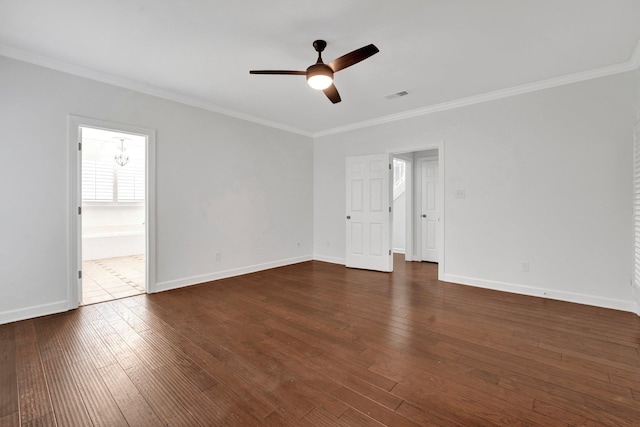 empty room featuring dark hardwood / wood-style flooring, ornamental molding, and ceiling fan