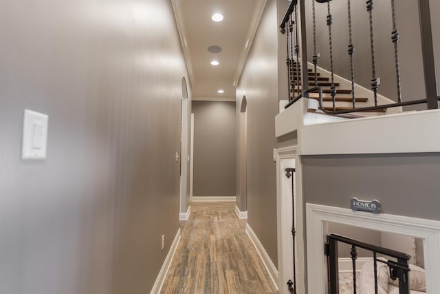 hall with hardwood / wood-style floors and crown molding