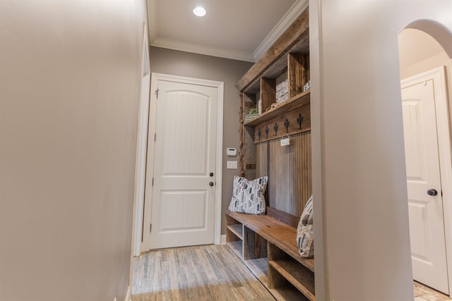 mudroom featuring crown molding and light hardwood / wood-style floors