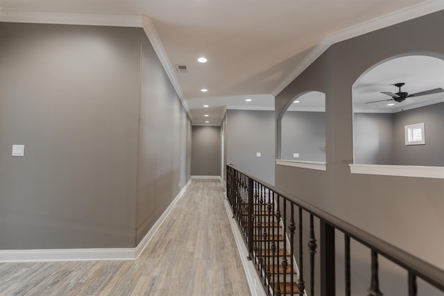 corridor featuring crown molding and light wood-type flooring