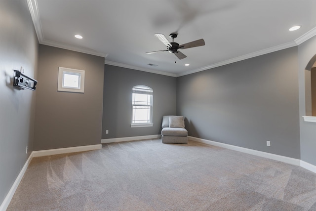 unfurnished room featuring ceiling fan, light colored carpet, and ornamental molding