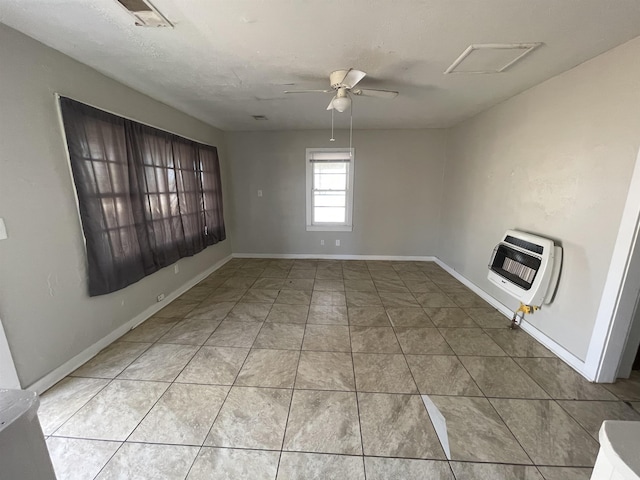 spare room featuring heating unit, tile patterned flooring, and ceiling fan