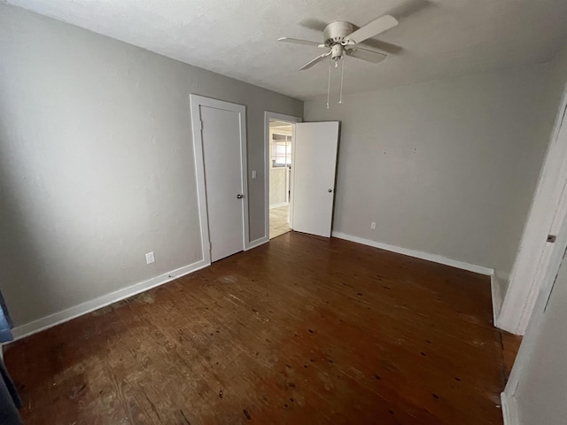 unfurnished bedroom featuring dark hardwood / wood-style flooring and ceiling fan