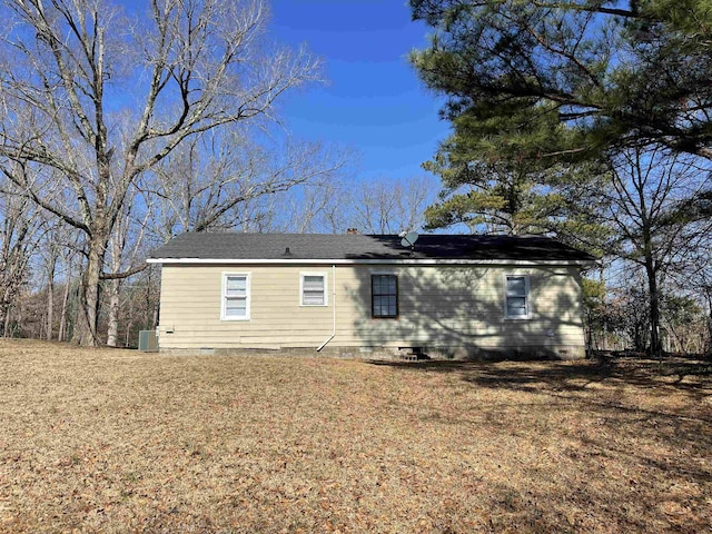 rear view of property featuring a yard