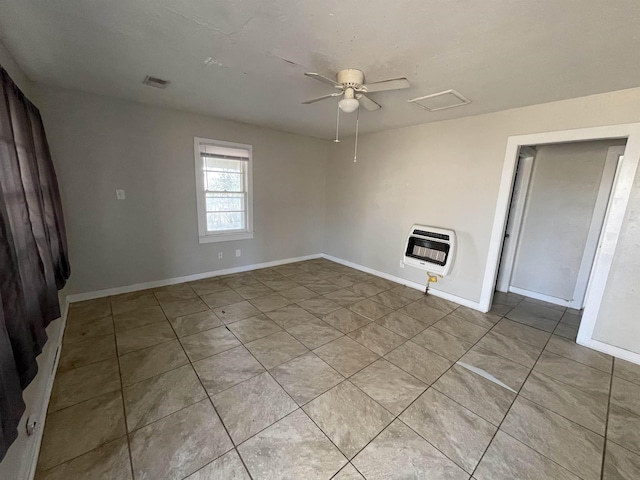 empty room featuring heating unit and ceiling fan