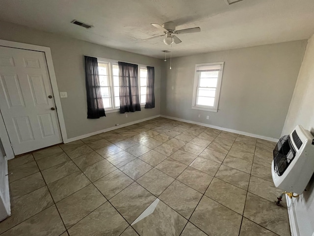 tiled foyer entrance with heating unit and ceiling fan