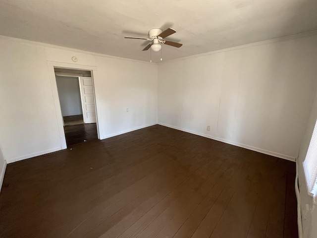 unfurnished room featuring dark hardwood / wood-style flooring, ornamental molding, and ceiling fan