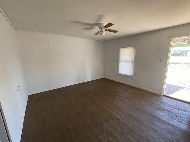 empty room with crown molding, ceiling fan, and dark hardwood / wood-style floors