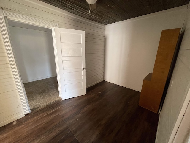 interior space with wood ceiling, dark hardwood / wood-style flooring, and wood walls