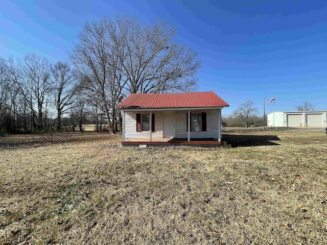 view of front of home featuring a garage, a front yard, and a porch