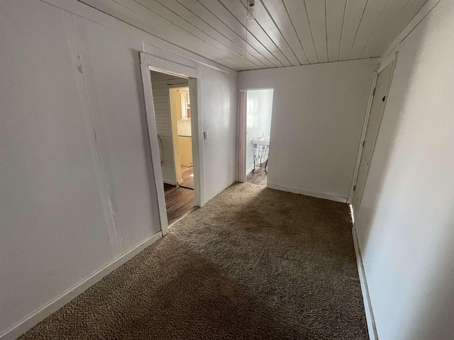 corridor featuring wood ceiling and carpet flooring