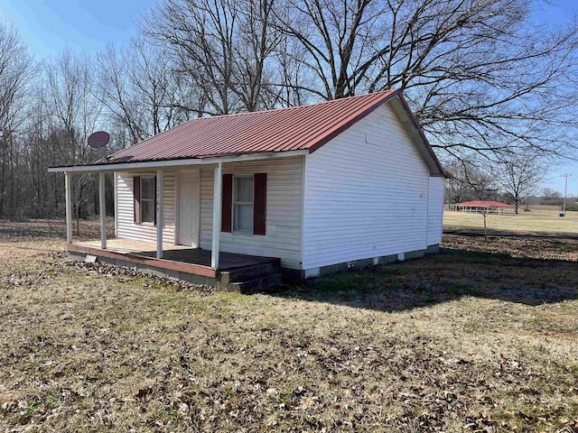 view of property exterior with a yard and covered porch