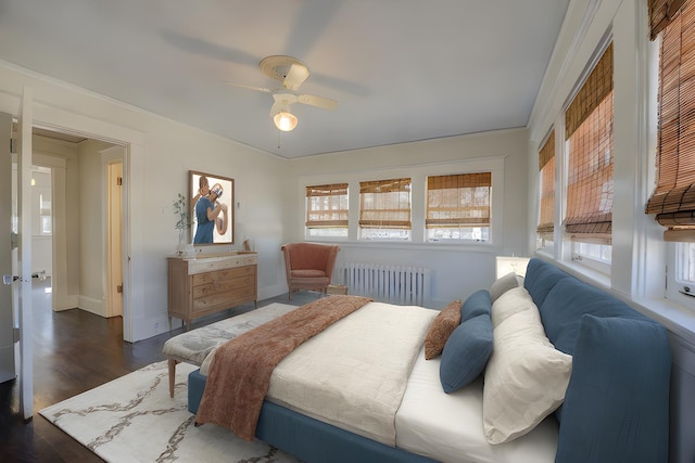 bedroom with dark hardwood / wood-style floors, ornamental molding, radiator, and ceiling fan