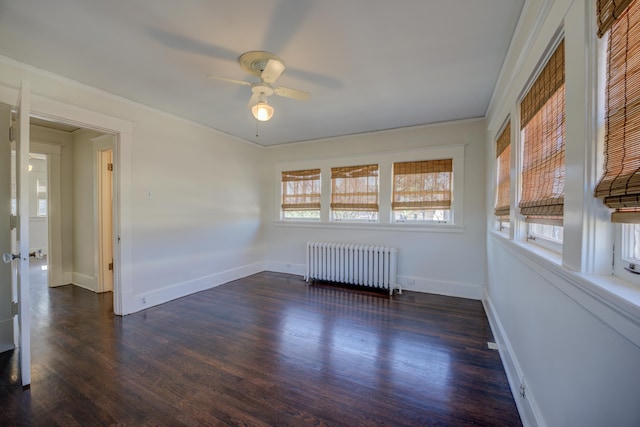 empty room with ceiling fan, ornamental molding, dark hardwood / wood-style floors, and radiator