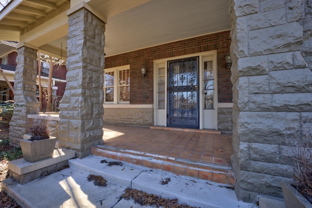 view of exterior entry with covered porch