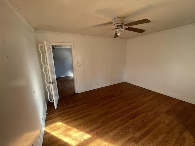 empty room with ceiling fan and dark hardwood / wood-style flooring