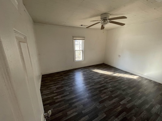 empty room with dark wood-type flooring and ceiling fan