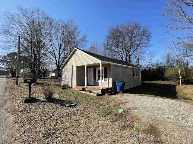 view of side of home with covered porch