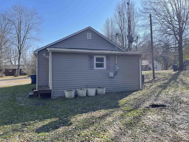 view of side of home featuring a yard