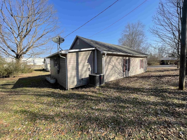 exterior space with a yard and central AC