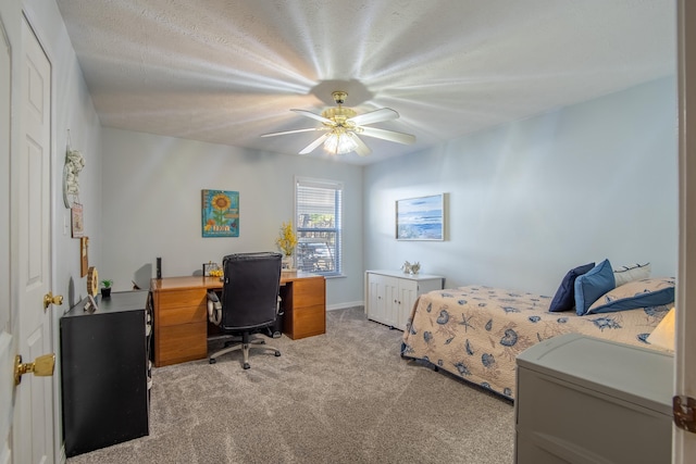 carpeted bedroom featuring a textured ceiling and ceiling fan