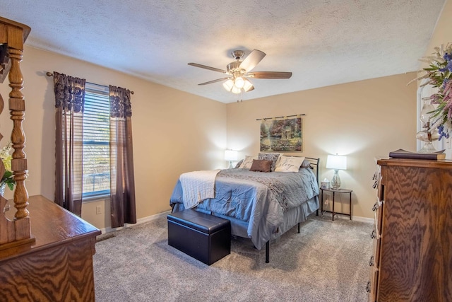 carpeted bedroom with ceiling fan and a textured ceiling