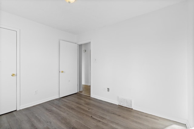 spare room featuring wood-type flooring